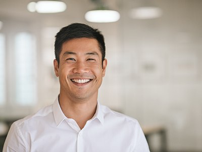 Man in white button-up shirt smiling