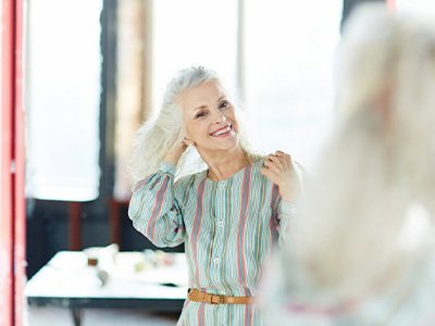 Woman admiring her teeth in mirror