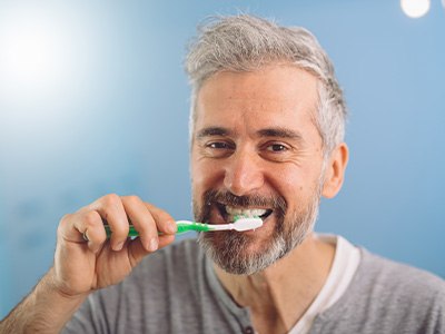 Middle-aged man brushing teeth