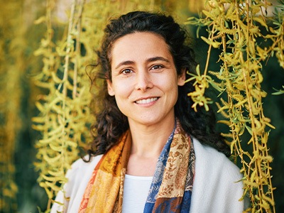 Woman wears casual scarf smiles with dental implants